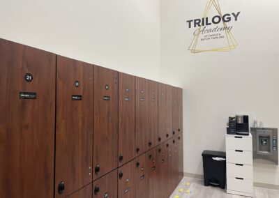 A brown-colored cupboard with a number and the Trilogy logo on it.